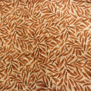 Fabric with abstract natural pattern in shades of orange, brown, and beige